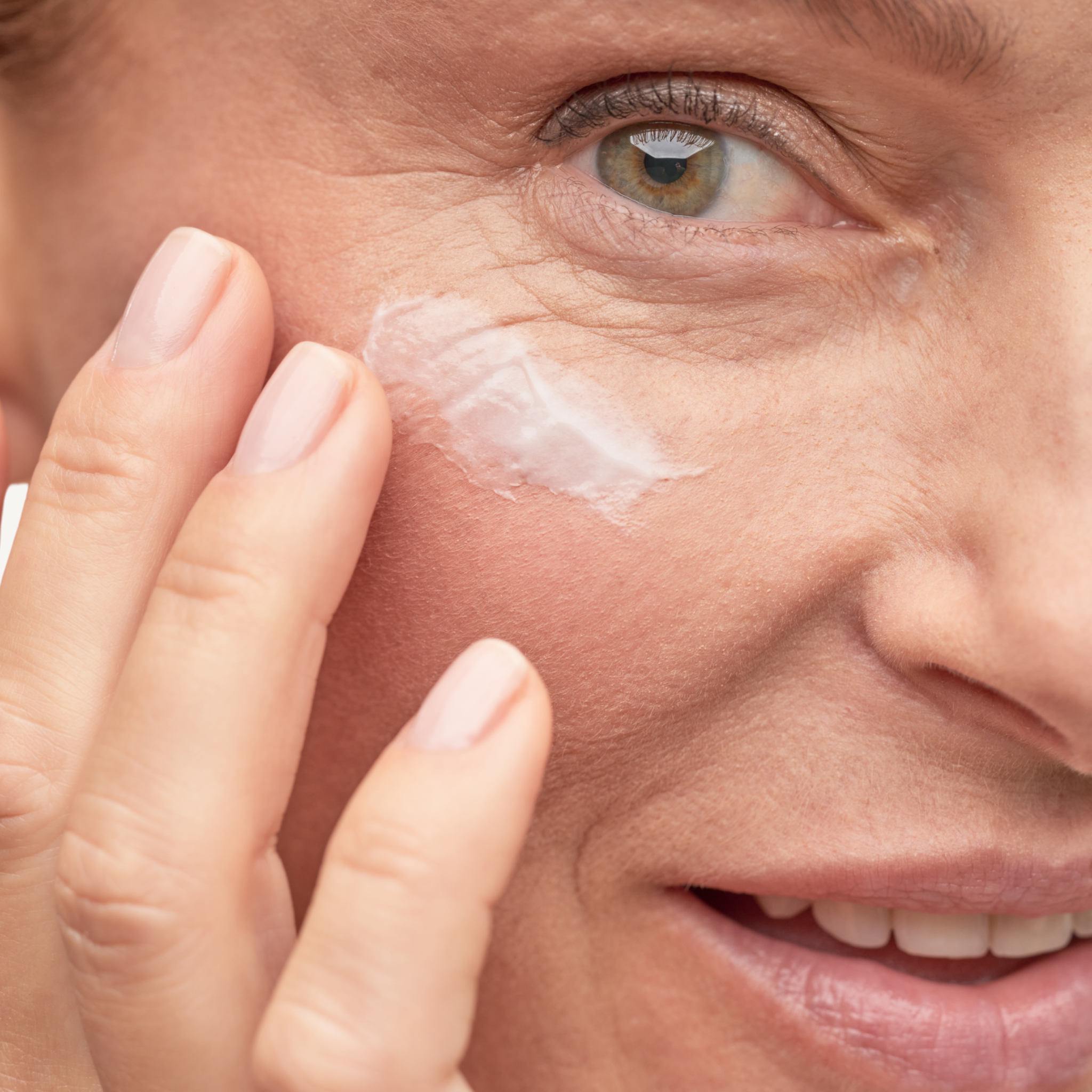 REBEL X EyeLift eye cream application photo showing mature woman applying white eye cream around eye area demonstrating proper skincare technique for crow's feet and under-eye treatment
