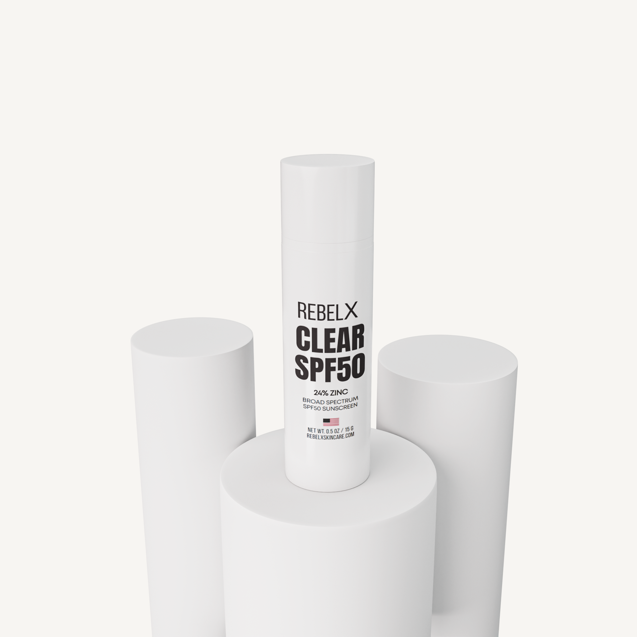 REBELX Clear SPF50 sunscreen with 24% zinc in white pump tube displayed on white geometric platforms, 0.5oz size