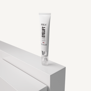 REBELX EyeLift eye cream in white tube displayed on white geometric platform, 0.5 fl oz size