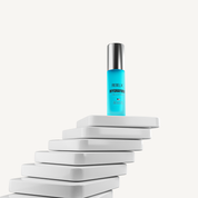 REBELX HydraFirm Cellular Serum in turquoise pump bottle with silver cap displayed on white geometric platform