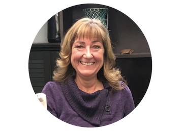 Woman wearing a purple sweater with a blurred background