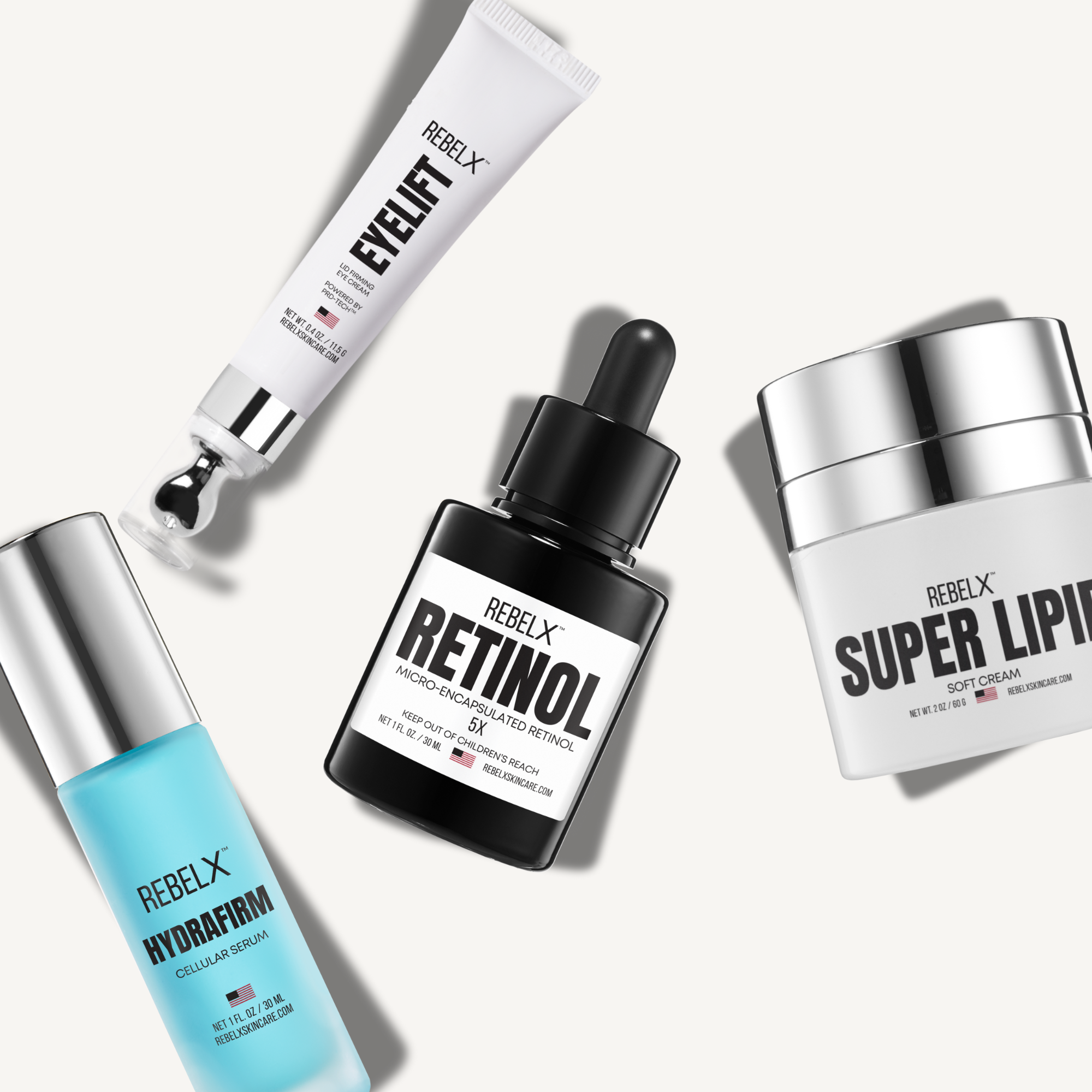 Collection of RebelX skincare products including a serum, cream, and dropper bottle on a white background.