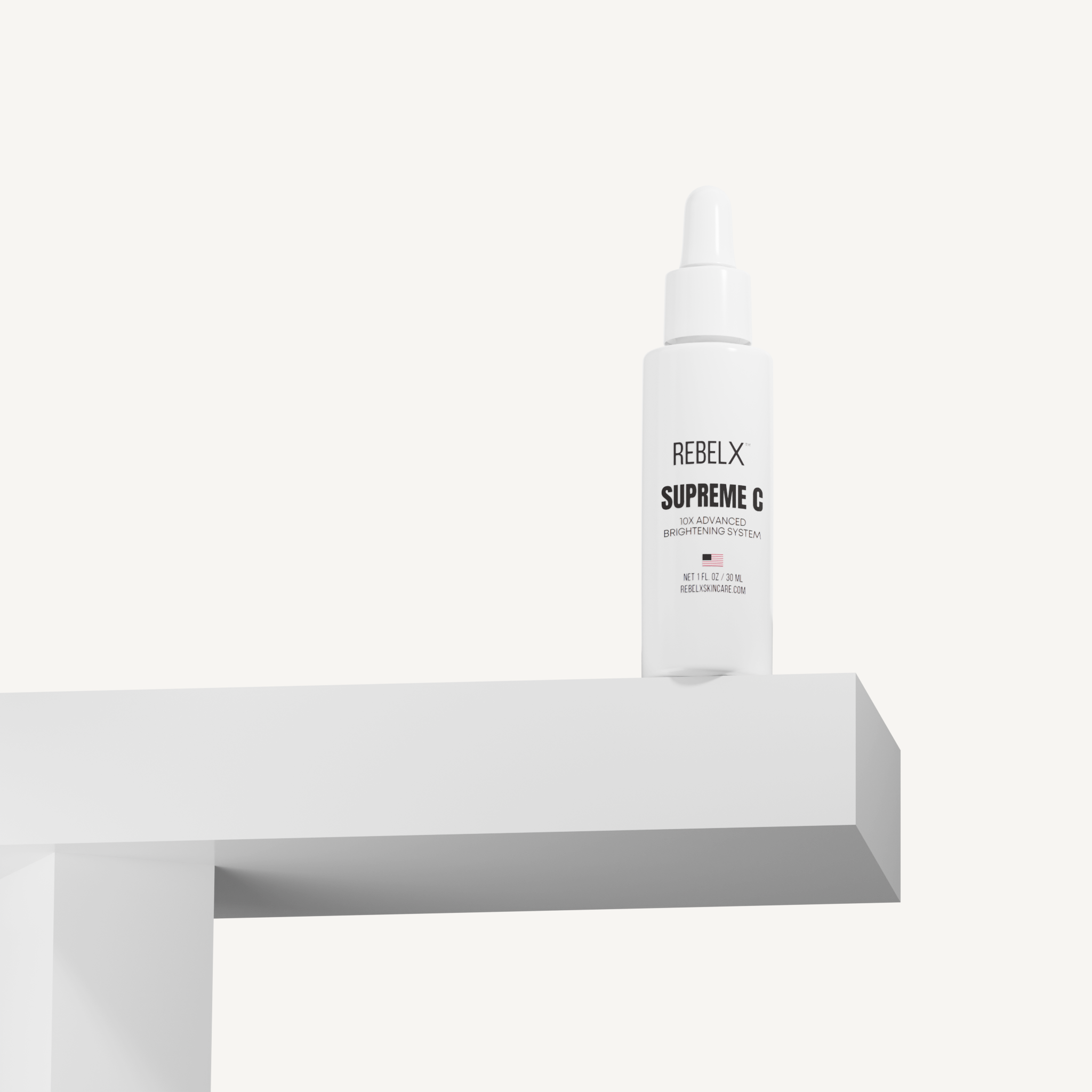 REBELX Supreme C vitamin C serum bottle with pump dispenser positioned on white geometric display block